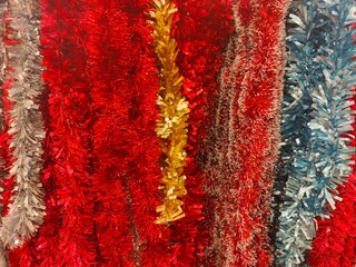 background of many garlands of colorful multicolored tinsel