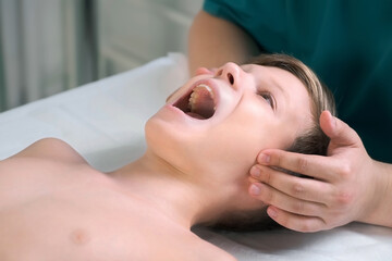 Session of craniosacral therapy, cure of teen boy's jaw by a doctor therapist. Craniosacral...