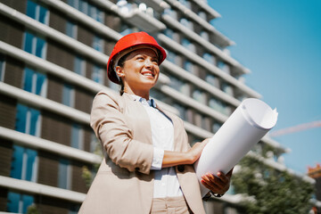 Young beautiful architect. Female engineer with her equipment. Businesswoman working on the new project