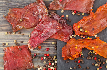 Jerky with spices on a wooden table