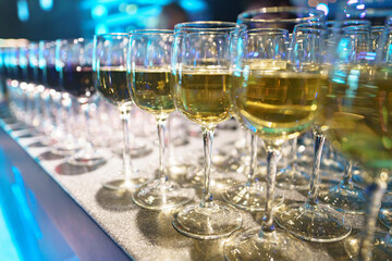 Glasses of delicious white and red wine on a bar counter,close up..Catering bar service, bartender workplace.Wine tasting and celebration concept/Glasses with wine