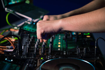 Fototapeta na wymiar Close-Up of Dj Mixer Controller Desk in Night Club Disco Party. DJ Hands touching Buttons and Sliders Playing Electronic Music . High quality photography.