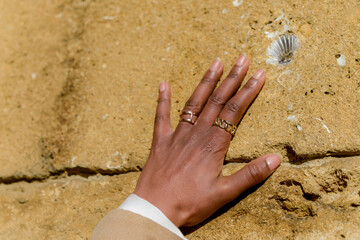 hand of an african woman on sand stone
