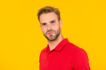 Fototapeta premium face of man in red shirt on yellow background, skincare