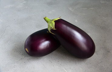 Eggplants on a rough background. Two eggplants.