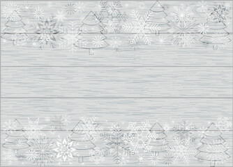 frame of white snowflakes and Christmas trees on a gray background with a wooden texture