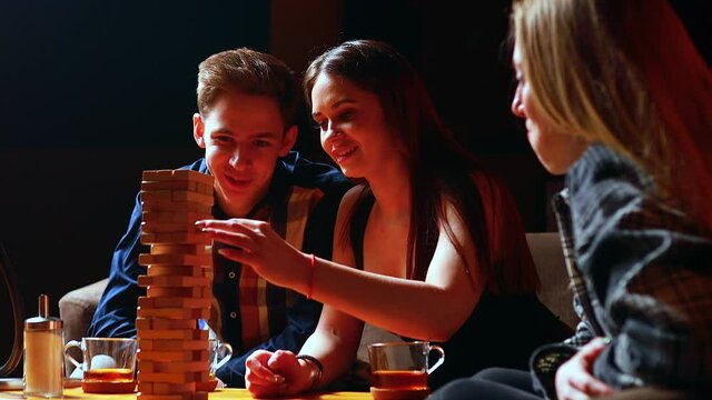 Authentic people Young people have fun playing board games at a table in cafe