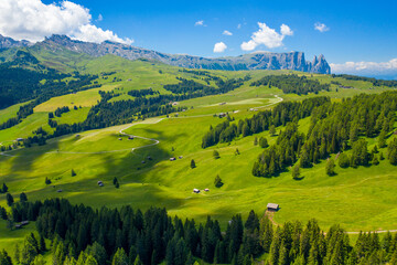 Seceda Mountains at the Dolomites, Trentino Alto Adige, Val di Funes Valley, South Tyrol in Italy, Odle Mountains in the background, Italy.