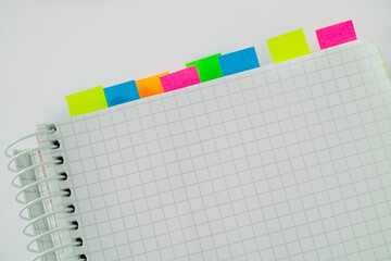 Open notebook with white blank paper with colored stickers on a white background. Copy space.