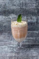  Ice cream glass with mint and cinnamon cream on gray marble