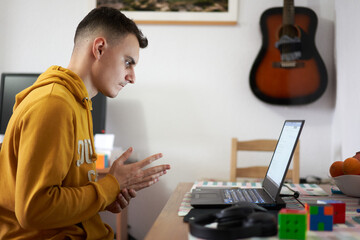 Student working from home on his laptop