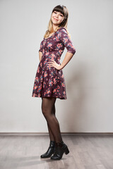 Fototapeta premium Beautiful young woman in a floral dress