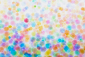Variegated multicolored blurry background of balls in the water, transparent balls and circles in countless numbers