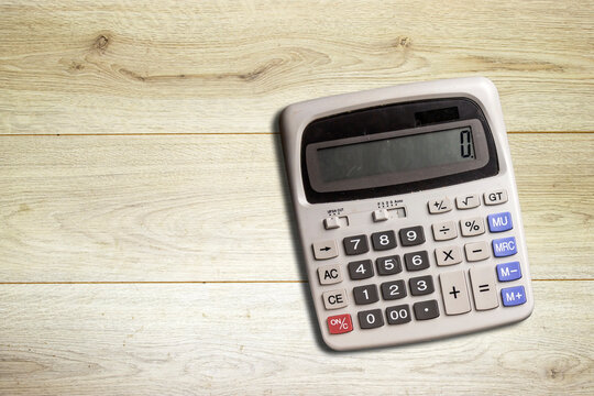gray big calculator isolated on wood table