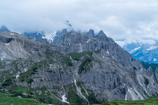 Trekking on a summer day in the tre cime valley, Dolomite italy. Alpine road, sunny day, clouds sky, trail, mountain