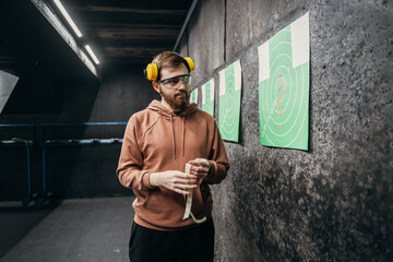 The man watches his hits from a distance. shooting range, sports entertainment