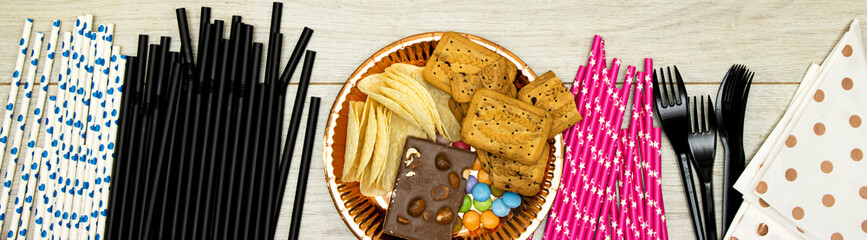happy birthday concept, Chocolate Candy and straw and chips potato, cookies with plastic forks on wood table