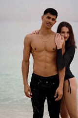 Fototapeta na wymiar Young interracial couple standing together at the beach