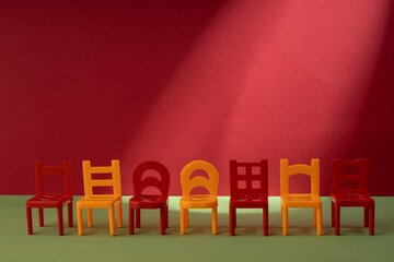 seven plastic chairs arranged in a row