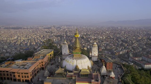 Black Kite raptors flying around Swayambhunath Stupa in Kathmandu viewing the city behind.