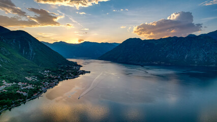 Photo of sunset in the Boko Kotor Bay, night city lights