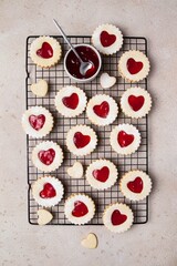 Linzer cookies in shape of heart with jam on light background. Mother's day, Women's day, Valentine's day. Homemade present.