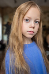 Fototapeta premium Caucasian teen happy blondie girl in blue cardigan