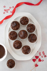 Valentine's day, top view of chocolate homemade muffins, cupcakes with heart sprinkles.