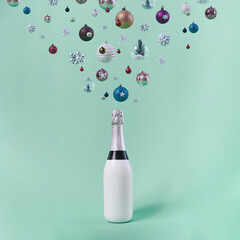 Celebrating Holydays. Creative and modern composition of Christmas baubles sparkling above champagne bottle.