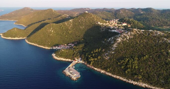 Aerial view of a small pier for ferry along the coast facing the Adriatic Sea near Lastovo, Croatia.