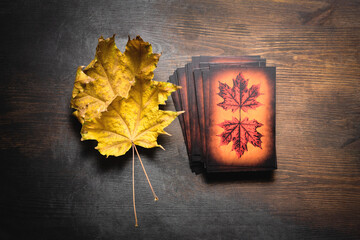 Tarot cards on the old dark wooden table.