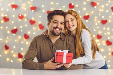 Saint Valentine's Day celebration, gift giving and romantic couple concept. Portrait of happy...