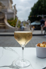 Drinking of brut champagne sparkling wine in street cafe in old central part of city Reims, Champagne, France