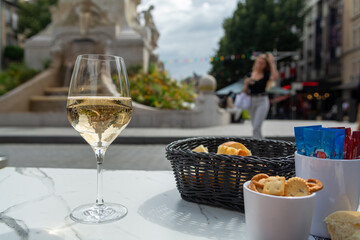 Drinking of brut champagne sparkling wine in street cafe in old central part of city Reims, Champagne, France