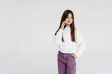 little girl with cellphone on white background