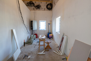 Working process of installing plasterboard or drywall for making gypsum walls in apartment is under...