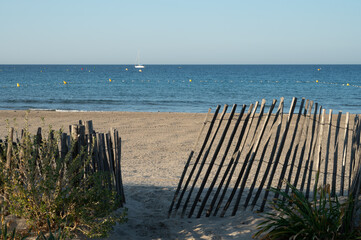 Fototapeta premium White sandy beach Les Sablettes in La Seyne-sur-mer in morning sunlights