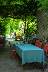 Traditional breakfast served outdoor on terrace in small village hotel in Provence