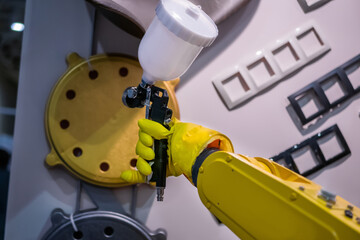 Automatic yellow spray painting robotic arm manipulator demonstrates functionality at smart robot...