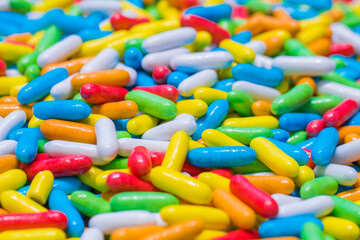 Colorful delicious glazed chocolate candies background, copy space, pattern - close up view. Dessert, sweet food and confectionery concept