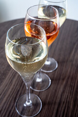 Tasting of white and rose champagne sparkling wine from flute glasses