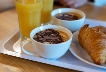 French breakfast with fresh baked croissants, coffee and orange juice