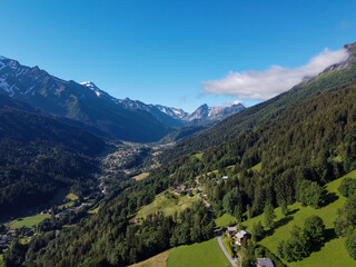 Fototapeta na wymiar Panoramic view on mountain villages, green forests and apline meadows near Saint-Gervais-les-Bains, Savoy. France
