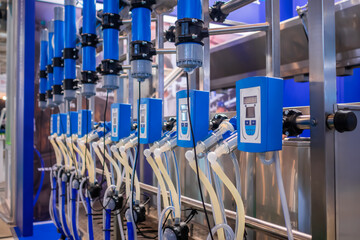 Automated goat milking suction machine with teat cups at cattle dairy farm, exhibition, trade show....