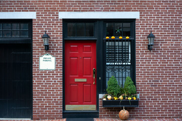 View of an entrance to an apartment building. Red door with windows