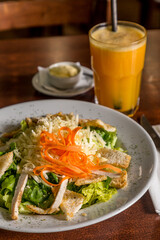 salad lettuce carrot mayonnaise croton on wood and orange juice