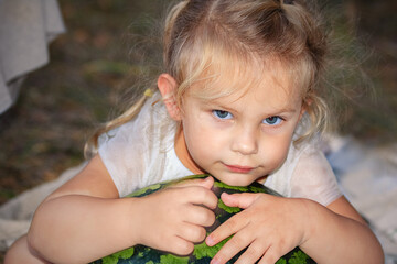 Portrait of a pensive little girl with blue eyes.