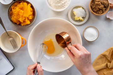 Process of cooking pumpkin cake, muffins or pumpkin dessert. Top view. Female hands. Step by step recipe.