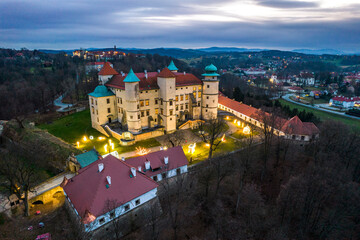 Nowy Wisnicz Castle Illuminated at Christmas Festive, Poland. Drone View - obrazy, fototapety, plakaty
