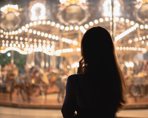 person at the carousel at night